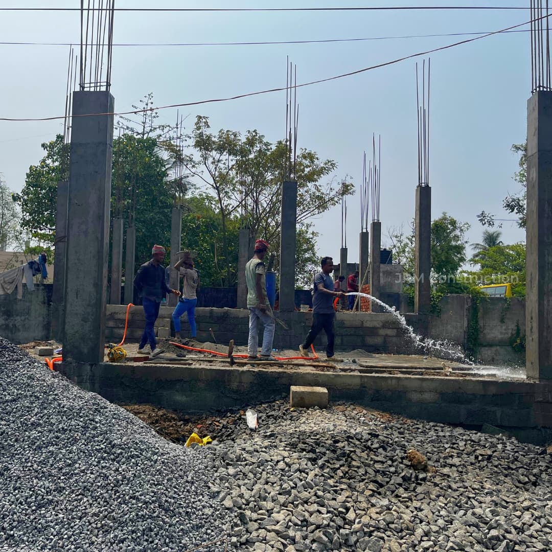 Pouring concrete into column molds
