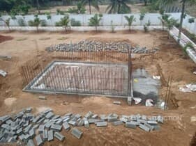Excavated swimming pool foundation showing concrete work in progress at JRM Construction's Mugaiyur project site