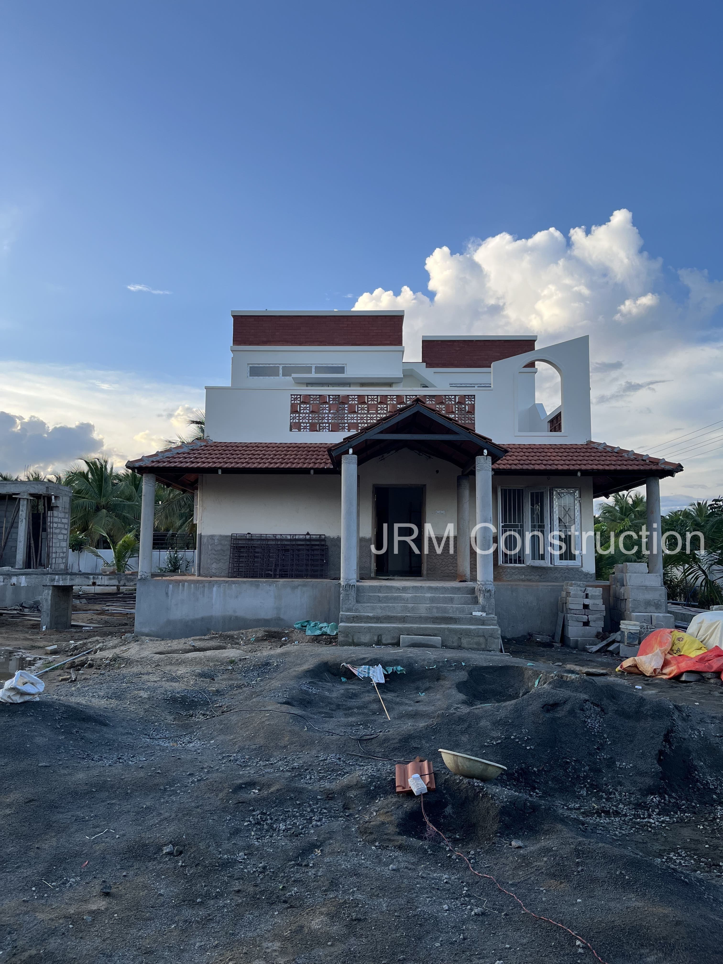 Front elevation view of farmhouse construction project in progress at Mugaiyur, Chennai - JRM Construction ongoing project