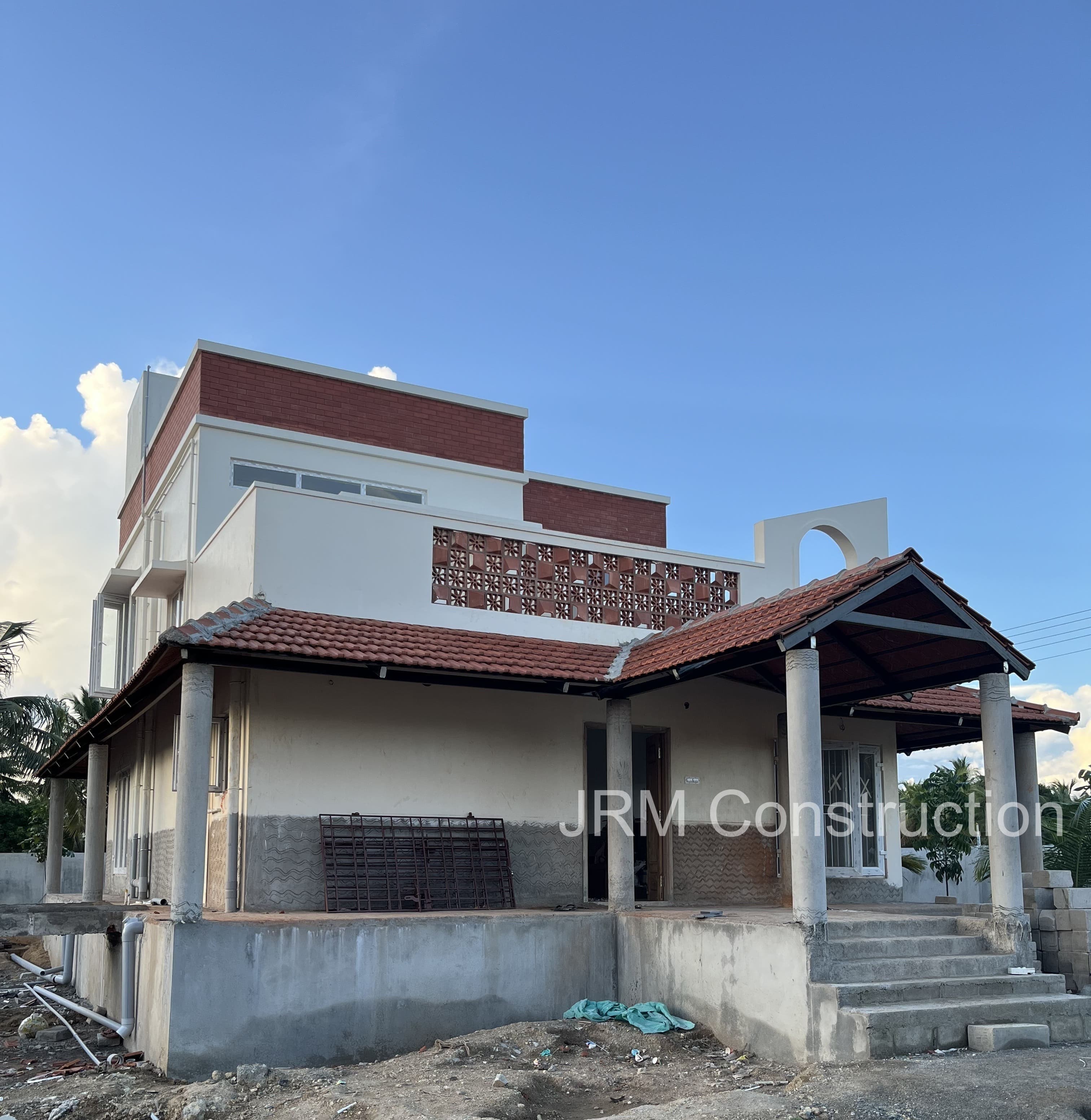 Left elevation view of farmhouse construction project in progress at Mugaiyur, Chennai - JRM Construction ongoing project