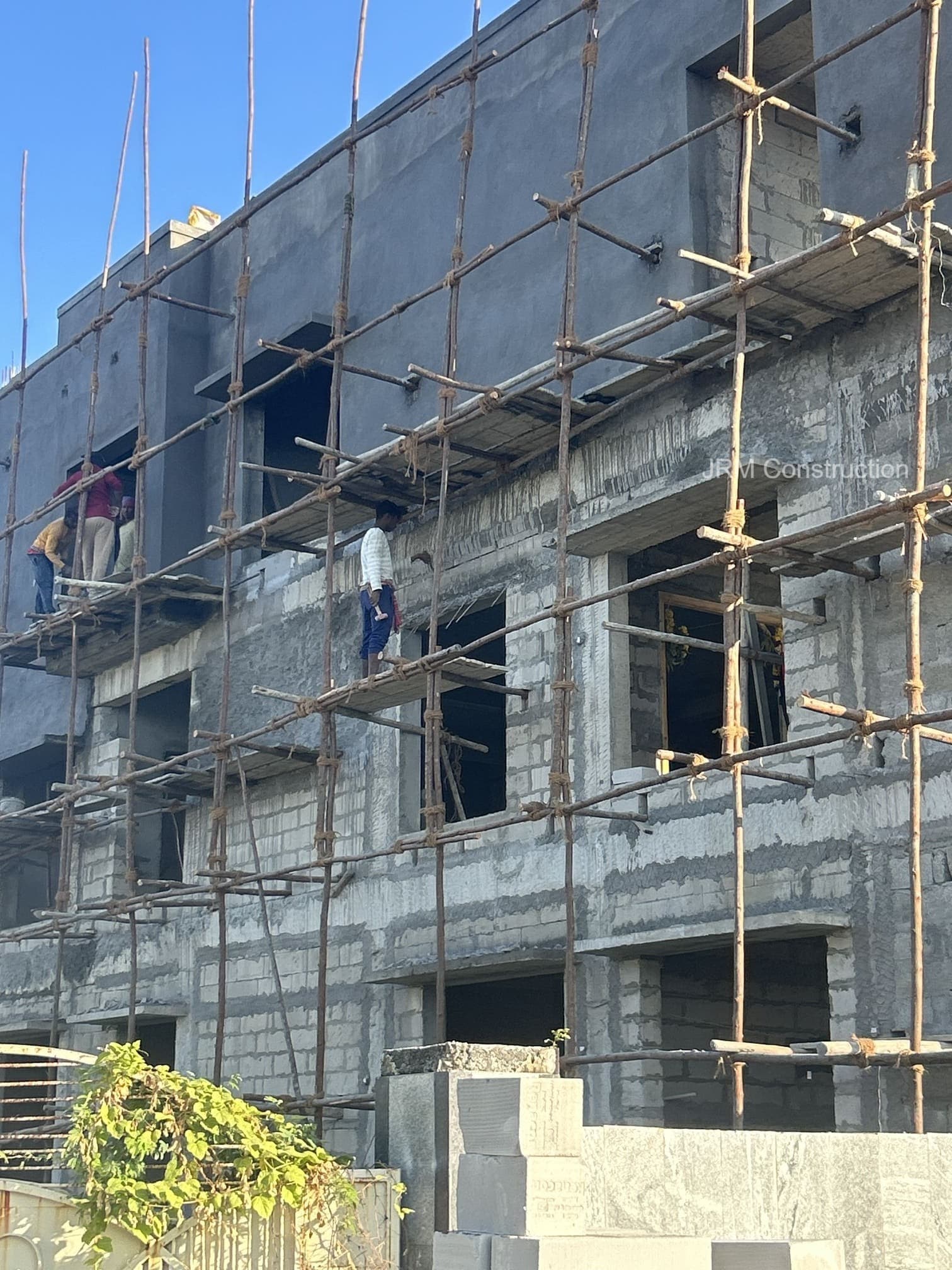 Construction of the outer wall structure with scaffolding support.