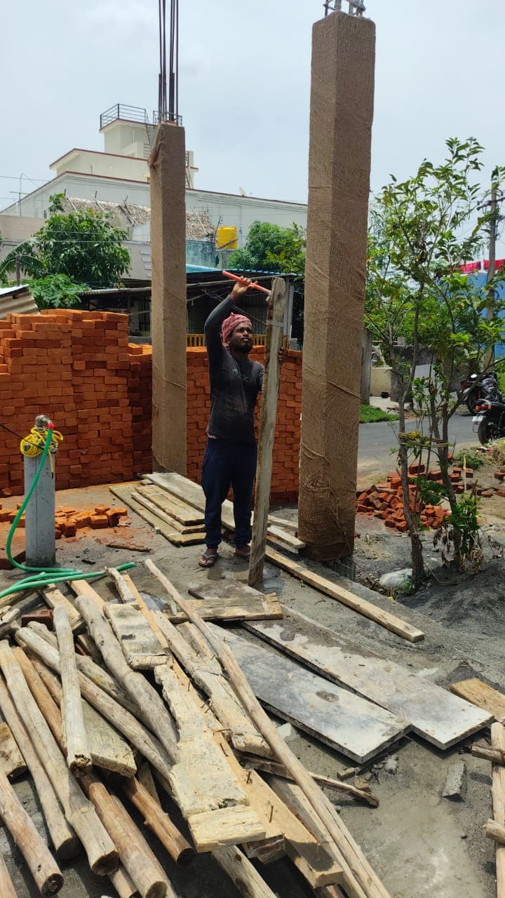 Worker lifting wood at site.jpg