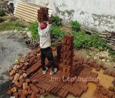 Worker stacking bricks.jpg